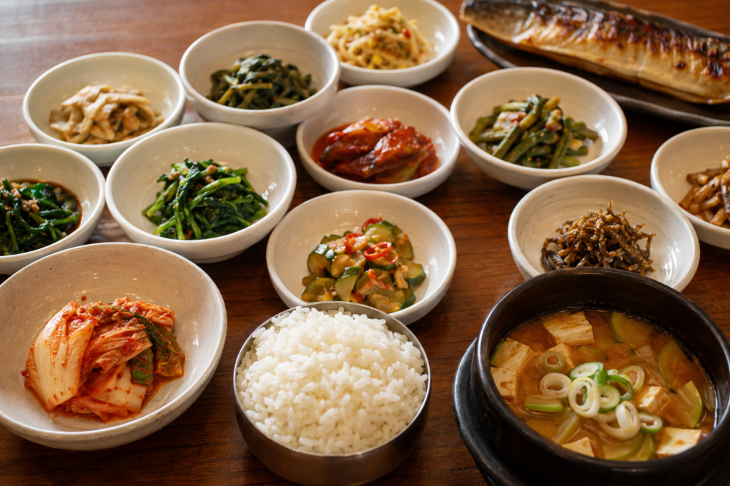 A traditional Korean meal with rice, stew, kimchi, and assorted banchan